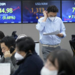 
              A currency trader reads documents at the foreign exchange dealing room of the KEB Hana Bank headquarters in Seoul, South Korea, Friday, Dec. 16, 2022. Asian shares followed Wall Street and Europe lower on Friday, with markets jittery over the risk that the Federal Reserve and other central banks may end up bringing on recessions to get inflation under control. (AP Photo/Ahn Young-joon)
            