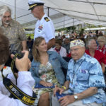 
              Pearl Harbor survivor Herb Elfring, 100, right, of Jackson, Mich., poses for a photo next to his granddaughter Leigh Anne Eaton before a ceremony on Wednesday, Dec. 7, 2022, in Pearl Harbor, Hawaii in remembrance of those killed in the 1941 attack. A handful of centenarian survivors of the attack on Pearl Harbor gathered at the scene of the Japanese bombing on Wednesday to commemorate those who perished 81 years ago. (AP Photo/Audrey McAvoy)
            
