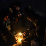 
              Venezuelan migrants build a campfire to keep warm at a makeshift camp along the Rio Grande river bank in Matamoros, Mexico, Thursday, Dec. 22, 2022. Migrants are waiting on a pending U.S. Supreme Court decision on asylum restrictions. (AP Photo/Fernando Llano)
            