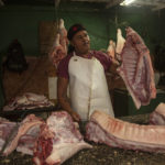 
              A meat vendor sells pork at a private market in Havana, Cuba, Friday, Dec. 23, 2022. (AP Photo/Ismael Francisco)
            