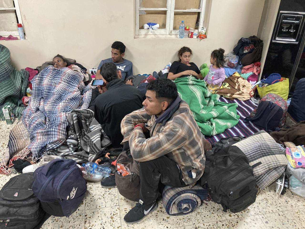 Migrants seek refuge from winter weather in a crowded shelter near the U.S. border in Ciudad Juáre...