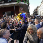 
              French President Emmanuel Macron and his wife Brigitte Macron greet the crowd as they arrive in New Orleans, Friday, Dec. 2, 2022. (AP Photo/Gerald Herbert)
            