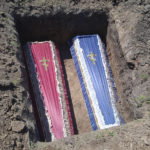 
              This photo provided by the family shows the coffins of two young cousins, Artem and Angelina Erashov, who were killed in Mariupol, Ukraine, during Russian shelling on March 9, 2022. Their parents fled Mariupol soon after but returned to the occupied city in July to rebury the children, ages 5 and 7, in the Staryi Krym cemetery, now the site of thousands of new graves since the Russian invasion began Feb. 24. (Family photo via AP)
            