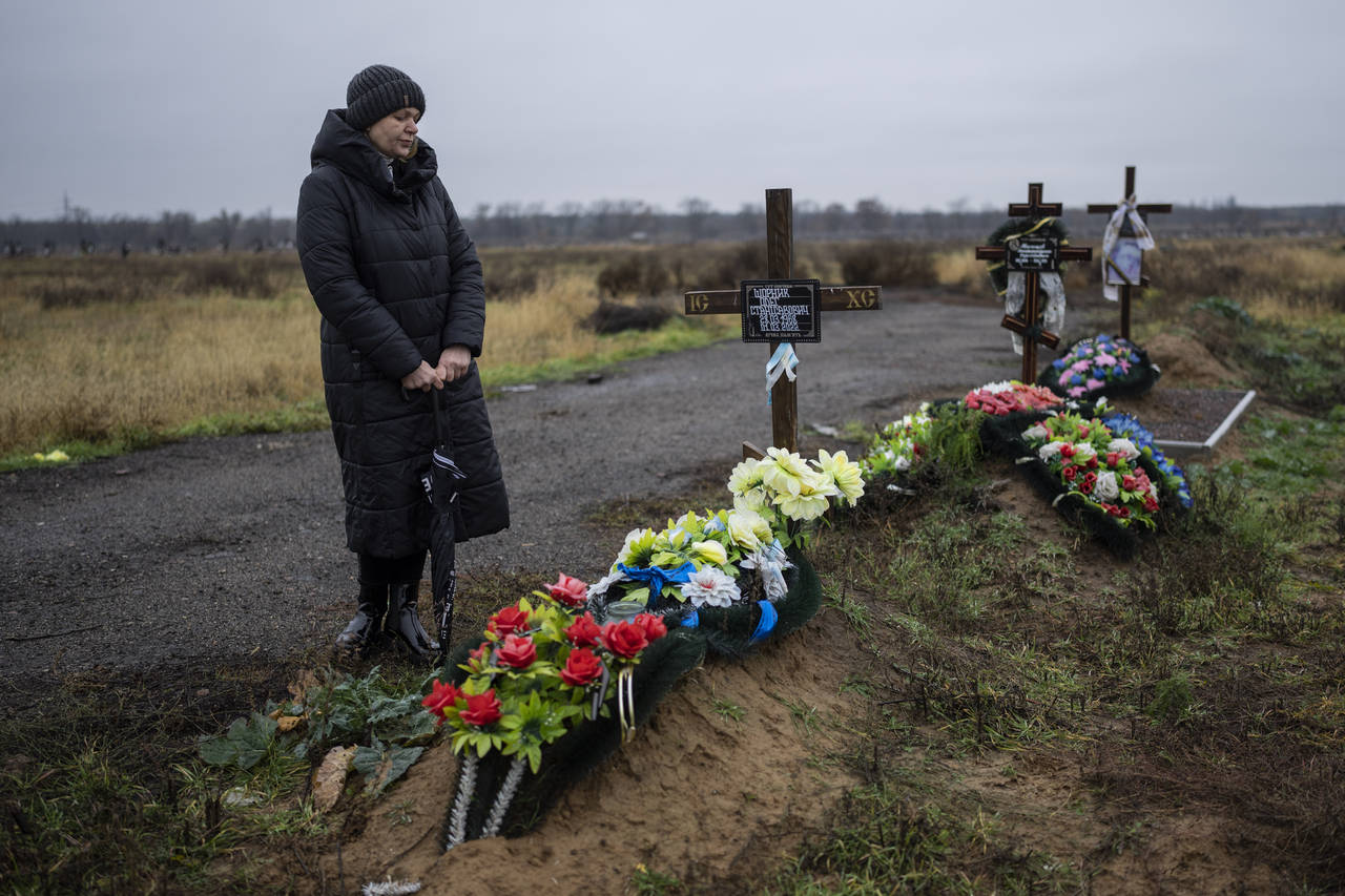 Svetlana Shornik stands next to the grave of her 53-year-old ex-husband, Oleh Shornik, on the outsk...