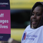 
              A nurse holds a placard on the picket line as she participates in a strike action over pay in London, Tuesday, Dec. 20, 2022. Nurses in England, Wales and Ireland will stage the biggest strike in the history of the Royal College of Nursing (RCN). Up to 100,000 members will walk out at 65 NHS (National Health Services) organisations. (AP Photo/Alastair Grant)
            