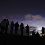 
              People watch the Mauna Loa volcano Thursday, Dec. 1, 2022, near Hilo, Hawaii. (AP Photo/Gregory Bull)
            