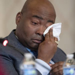 
              Democratic National Committee chair Jaime Harrison cries while listening to committee member Donna Brazile talk about the importance of proposed changes to the primary system during a DNC Rules and Bylaws Committee meeting to discuss President Joe Biden's presidential primary lineup at the Omni Shoreham Hotel on Friday, Dec. 2, 2022, in Washington. (AP Photo/Nathan Howard)
            