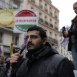 
              Agit Polat, spokesman of the Kurdish Democratic Counsel in France, speaks during a march to honor three women Kurdish activists who were shot dead in 2013, Monday, Dec. 26, 2022 in Paris. A 69-year-old Frenchman is facing preliminary charges of racially motivated murder, attempted murder and weapons violations over last Friday's shooting, prosecutors said. The shooting shocked and infuriated the Kurdish community in France. ( AP Photo/Lewis Joly)
            