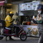 
              A delivery man eats his breakfast at a store in Beijing, Thursday, Dec. 15, 2022. A week after China eased some of the world's strictest COVID-19 containment measures, uncertainty remains over the direction of the pandemic in the world's most populous nation. (AP Photo/Ng Han Guan)
            