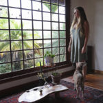 
              Lindsay Cloyd and her dog, Lily, stand inside their home, Tuesday, Nov. 29, 2022, in Hilo, Hawaii. (AP Photo/Marco Garcia)
            
