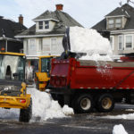 
              A front end loader dump snow into a dump truck as crews clear large amounts of snow, Wednesday, Dec. 28, 2022, in Buffalo N.Y., days after a winter storm passed through. (AP Photo/Jeffrey T. Barnes)
            