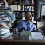 
              FILE - Dr. Anthony Fauci, director of the National Institute for Allergy and Infectious Diseases, works at his desk in his office at the National Institutes of Health, Dec. 19, 2017, in Bethesda, Md. Fauci steps down from a five-decade career in public service at the end of the month, one shaped by the HIV pandemic early on and the COVID-19 pandemic at the end.  (AP Photo/Carolyn Kaster, File)
            