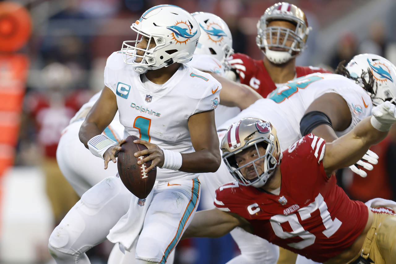 Miami Dolphins quarterback Tua Tagovailoa (1) looks to pass before San Francisco 49ers defensive en...