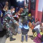 
              Indonesian soldiers help ethnic Rohingya women and children to step out of a military truck upon arrival at a temporary shelter after their boat landed in Pidie, Aceh province, Indonesia, Monday, Dec. 26, 2022. A second group in two days of weak and exhausted Rohingya Muslims landed on a beach in Indonesia's northernmost province of Aceh on Monday after weeks at sea, officials said. (AP Photo/Rahmat Mirza)
            