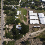 
              Tents are set up by Mexican migration authorities in San Pedro Tapanatepec, Oaxaca, Mexico Wednesday, Oct. 5, 2022. Officials here issued transit permits until the camp was closed in mid December. Before getting here, some migrants said they spent several days in detention in Tapachula; others said they were released immediately. Some were let go for free and others after paying up to $500 to a lawyer. (AP Photo/Marco Ugarte)
            