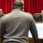 
              Nevada Attorney General Aaron Ford, left, and Gov. Steve Sisolak, listen to former Nevada death row inmate James Allen, speaking in favor of an incarcerated man during a pardons board meeting at the Nevada Supreme Court in Las Vegas, Tuesday, Dec. 20, 2022. (Erik Verduzco/Las Vegas Review-Journal via AP)
            