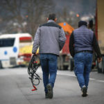 
              Serb truck drivers carrying jump cables walk toward trucks to remove them from Rudare barricade near the northern, Serb-dominated part of ethnically divided town of Mitrovica, Kosovo, Thursday, Dec. 29, 2022. Serbia on Thursday revoked combat readiness of its troops on the border with Kosovo as local Serbs started removing more than a dozen of the roadblocks they had set up in the north of the state, in a sign of easing of tensions that have sparked fears of a new conflict in the Balkans. (AP Photo/Visar Kryeziu)
            