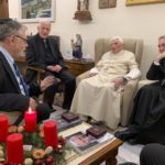 
              Pope Emeritus Benedict XVI, third from left, meets with the winners of the 2022 Ratzinger Prize, Joseph Halevi Horowitz Weiler, left, and father Michel Fedou, partially hidden at right, at the Mater Ecclesiae monastery inside the Vatican where Benedict XVI lives, in this photo taken Thursday, Dec. 1, 2022. Second from left, is the foundation's president Father Federico Lombardi, and fourth from left is Benedict XVI's long-time personal secretary Bishop Georg Gänswein. (Fondazione Vaticana J.Ratzinger via AP)
            