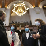 
              Ximean Fuentes, Chile's vice-minister for foreign affairs, second left, Chilean lawyer Carolina Valdivia Torres, right, and Bolivian Foreign Minister, Rogelio Mayta, second right talk prior to the reading of the verdict at the World Court in The Hague, Netherlands, Thursday, Dec. 1, 2022, where the UN's top court rules on a dispute about a river that crosses Chile's and Bolivia's border, in a case seen as important jurisprudence at a time when fresh water is becoming an increasingly coveted world resource. (AP Photo/Peter Dejong)
            