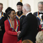 
              President Joe Biden shakes hands with performer Gladys Knight during the Kennedy Center honorees reception at the White House in Washington, Sunday, Dec. 4, 2022. Composer and conductor Tania León, right, and back row from left, Irish band U2 members, Bono, The Edge and Adam Clayton, look on. (AP Photo/Manuel Balce Ceneta)
            