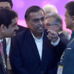 
              FILE- Adani Group Gautam Chairman Gautam Adani, left, Reliance Industries Chairman Mukesh Ambani, center, and Mahindra Group Chairman Anand Mahindra interact as they attend 'UP Investors Summit 2018' in Lucknow, India, Feb. 21, 2018. Asia’s richest man, Gautam Adani, made his vast fortune betting on coal as an energy hungry India grew swiftly after liberalizing its economy in the 1990s. He's now set his sights on becoming world's biggest renewable energy player, by 2030, adroitly aligning his investments with the government’s own priorities. (AP Photo/Rajesh Kumar Singh, File)
            