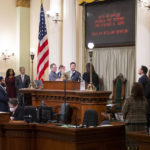 
              Assemblyman Christopher Ward, is accompanied by his partner Thom Harpole, and children Betty and Billy as he is sworn in as Speaker Pro Tempore during the opening session of the California Legislature in Sacramento, Calif., Monday, Dec. 5, 2022. The legislature returned to work on Monday to swear in new members and elect leaders for the upcoming session. (AP Photo/José Luis Villegas, Pool)
            