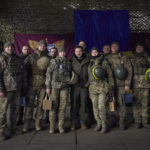 
              In this photo provided by the Ukrainian Presidential Press Office, Ukrainian soldiers pose for a photo with President Volodymyr Zelenskyy, center, during his visit to to Sloviansk, Donbas region, Ukraine, Tuesday, Dec. 6, 2022. (Ukrainian Presidential Press Office via AP)
            