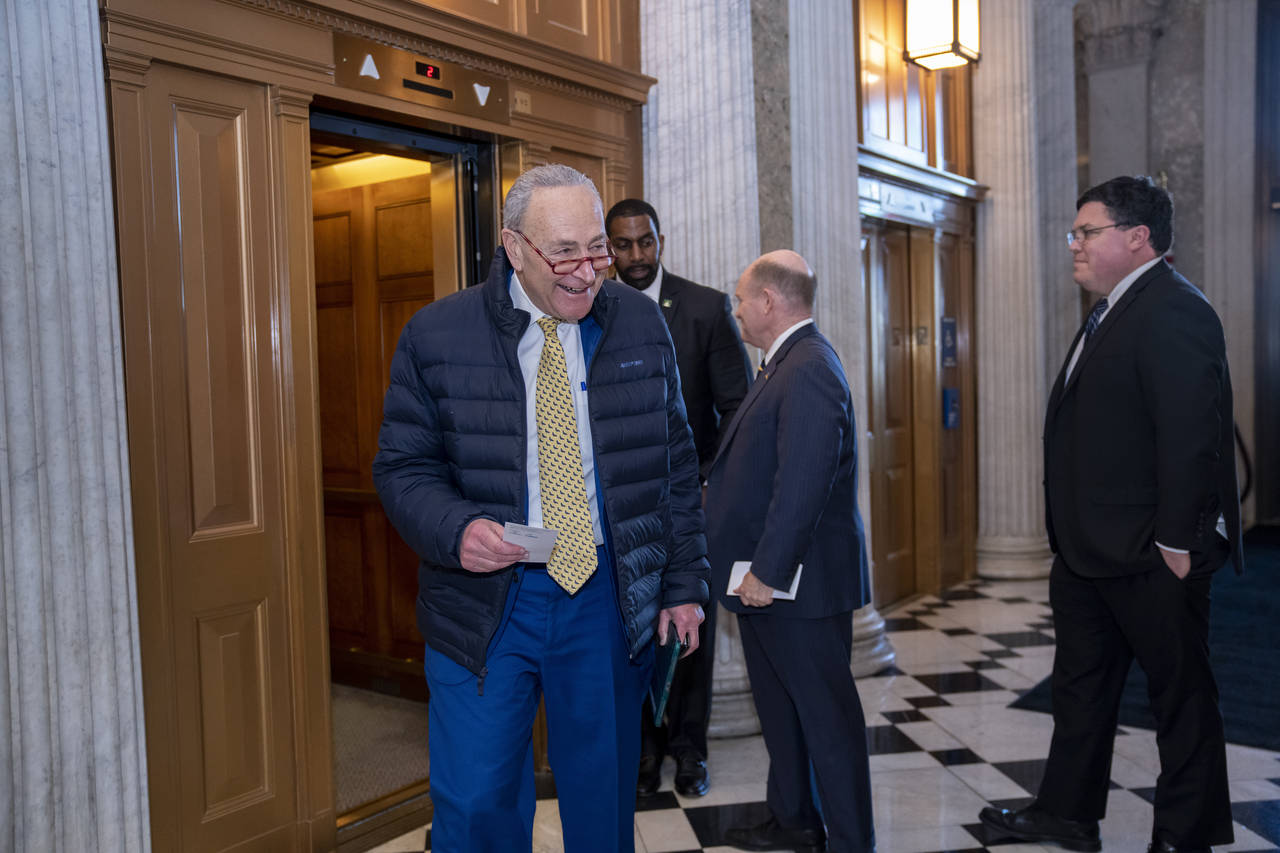 Senate Majority Leader Chuck Schumer, D-N.Y., walks to the chamber after speaking with Sen. Chris C...