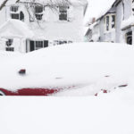 
              A stranded car is seen in a neighborhood of Buffalo, N.Y.'s Elmwood Village on Monday, Dec. 26, 2022. Clean up is currently under way after a blizzard hit four Western New York counties. (Joseph Cooke/The Buffalo News via AP)
            