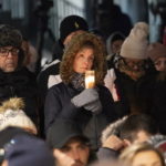 
              Members of the public attend a candlelight vigil for victims of a deadly condominium shooting in Vaughan, Ontario, on Wednesday, Dec. 21, 2022. (Arlyn McAdorey/The Canadian Press via AP)
            