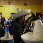 
              A music participate in the procession of "Ninopan" during a Christmas "posada," which means lodging or shelter, in the Xochimilco borough of Mexico City, Wednesday, Dec. 21, 2022. For the past 400 years, residents have held posadas between Dec. 16 and 24, when they take statues of baby Jesus in procession to church for Mass to commemorate Mary and Joseph's cold and difficult journey from Nazareth to Bethlehem in search of shelter. (AP Photo/Eduardo Verdugo)
            