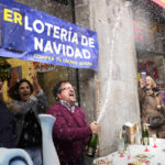 
              The owner of a lottery administration celebrates the sale of one of the lottery tickets known as "El Gordo," or The Fat One, sold in his store in Madrid, Spain, Thursday, Dec. 22, 2022. Spain has kicked off the festive period with one of its most iconic events: the huge Christmas lottery, known as "El Gordo," or The Fat One. The most sought-after prize shells out 400,000 euros ($425,000), or some 325,000 euros after tax, to winning holders of 20-euro tickets, known as "décimos."(AP Photo/Paul White)
            