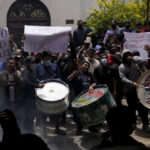 
              San Pedro inmates protest against the possible transfer of Santa Cruz Gov. Luis Fernando Camacho to the detention facility in La Paz, Bolivia, Thursday, Dec. 29, 2022. Police on Wednesday detained Camacho, the main opposition leader in Bolivia, near his Santa Cruz home. The Chief Prosecutor’s Office said Camacho was detained as part of a case in which he is accused of leading what the government characterizes as a coup in 2019. (AP Photo/Juan Karita)
            