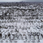 
              An aerial view of the 1901 Pan-American Exposition neighborhood in Buffalo, N.Y., which remains coated in a blanket of snow after a blizzard, Tuesday, Dec. 27, 2022. State and military police were sent Tuesday to keep people off Buffalo’s snow-choked roads, and officials kept counting fatalities three days after western New York’s deadliest storm in at least two generations. (Derek Gee/The Buffalo News via AP)
            