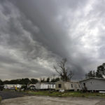 
              Dark clouds hang over Bradley Lane after a tornado destroyed several mobile homes in the area, Wednesday, Dec. 14, 2022, in New Iberia, La. (Leslie Westbrook/The Times-Picayune/The New Orleans Advocate via AP)
            