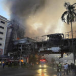 
              In this photo provided by Cambodia's Fresh News, smoke rises as a fire burns through a Cambodian hotel casino near a Cambodia-Thai international border gate in Poipet, west of Phnom Penh, Cambodia, Wednesday, Dec. 28, 2022. A fire burning through the Grand Diamond City Casino and Hotel has killed multiple people and injured dozens of others, police said Thursday, and neighboring Thailand sent firetrucks to help fight the blaze in a bustling border region. (Fresh News/Photo via AP)
            