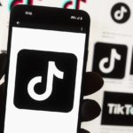 
              FILE - The TikTok logo is seen on a cell phone on Oct. 14, 2022, in Boston. Georgia Gov. Brian Kemp on Thursday, Dec. 15, 2022, immediately banned the use of TikTok and two popular messaging applications from all computer devices controlled by Georgia's state government, saying the Chinese government may be able to access users' personal information. (AP Photo/Michael Dwyer, File)
            