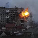 
              FILE - An explosion erupts from an apartment building at 110 Mytropolytska St., after a Russian army tank fired on it in Mariupol, Ukraine, Friday, March 11, 2022. (AP Photo/Evgeniy Maloletka, File)
            