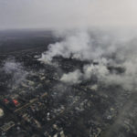 
              Smoke billows after Russian attacks in the outskirts of Bakhmut, Ukraine, Tuesday, Dec. 27, 2022. (AP Photo/Libkos)
            