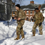 
              National guard members check on residents, Wednesday, Dec. 28, 2022, in Buffalo N.Y., following a winter storm. (AP Photo/Jeffrey T. Barnes)
            