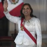 
              Peru's President Dina Boluarte waves as she arrives to swear in her cabinet members at the government palace in Lima, Peru, Saturday, Dec. 10, 2022.  (AP Photo/Guadalupe Pardo)
            