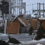 
              Kiosks lay on their side at the Christmas German Market on the Dufferin Terrasse, as a major storm hits eastern Canada, Friday, Dec. 23, 2022 in Quebec City. Strong winds with gusts at over 105 kph (65 mph) caused the kiosks to flip. (Jacques Boissinot/The Canadian Press via AP)
            