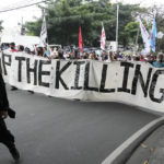 
              Protesters hold a banner as they march during a rally as they commemorate International Human Rights Day, Saturday, Dec. 10, 2022, in Manila, Philippines. Hundreds of people marched in the Philippine capital on Saturday protesting what they said was a rising number of extrajudicial killings and other injustices under the administration of President Ferdinand Marcos Jr. (AP Photo/Aaron Favila)
            