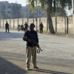 
              Security officials guard a blocked road leading to a counter-terrorism center after security forces starting to clear the compound seized earlier by Pakistani Taliban militants in Bannu, a northern district in the Pakistan's Khyber Pakhtunkhwa province, Tuesday, Dec. 20, 2022. Pakistan's special forces on Tuesday stormed the counter-terrorism center to free several security officials who were taken hostage earlier this week by a group of detained Pakistani Taliban militants, security officials said. (AP Photo/Muhammad Hasib)
            