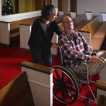 
              Laura Lamb talks to her husband, Jerry Lamb, who suffers from a spine condition, as they make their way through the sanctuary at Camden First United Methodist Church Thursday, Dec. 8, 2022, in Camden, Tenn. The church recently had a couple pews cut in half so Jerry, and anyone else who uses a wheelchair, walker or other aid, can still sit with the rest of the congregation. (AP Photo/John Amis)
            