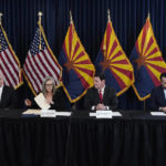 
              Katie Hobbs, the Democratic governor-elect and current secretary of state, second from left, signs the official certification for the Arizona general election canvass in a ceremony as Arizona Republican Gov. Doug Ducey, second from right, Arizona Supreme Court Chief Justice Robert Brutinel, left, and Arizona Attorney General Mark Brnovich flank Hobbs at the Arizona Capitol in Phoenix, Monday, Dec. 5, 2022. (AP Photo/Ross D. Franklin, Pool)
            