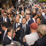 
              French President Emmanuel Macron reacts to crowds as he walks down Royal Street with New Orleans Mayor Latoya Cantrell and former Mayor Mitch Landrieu, right, in the French Quarter of New Orleans, Friday, Dec. 2, 2022. (AP Photo/Gerald Herbert)
            