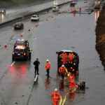 
              The three right lanes of traffic on westbound 580 near 35th Avenue are blocked while crews try to clear the roadway of major flooding as a strong atmospheric river moves over Oakland, Calif., Tuesday, Dec. 27, 2022. (Jessica Christian/San Francisco Chronicle via AP)
            