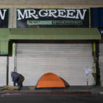 
              FILE - A homeless man stands next to his tent in Los Angeles, Wednesday, Dec. 14, 2022. Los Angeles. President Joe Biden's Administration announced Monday, Dec. 19 it is ramping up efforts to help house people now sleeping on sidewalks, in tents and cars as a new federal report confirms what's obvious to people in many cities: Homelessness is persisting despite increased local efforts.  (AP Photo/Jae C. Hong, File)
            