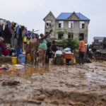 
              Residents clean up following torrential rains in Kinshasa, Democratic Republic of Congo, Tuesday, Dec. 13, 2022. At least 100 people have been killed and dozens injured by widespread floods and landslides caused by the rains. (AP Photo/Samy Ntumba Shambuyi)
            